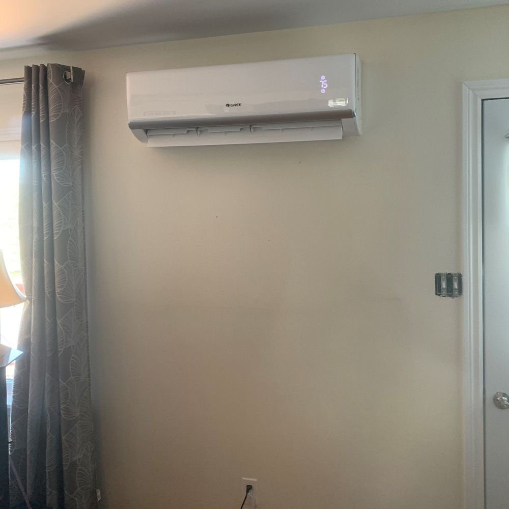 Gree ductless mini-split head installed high on a living room wall